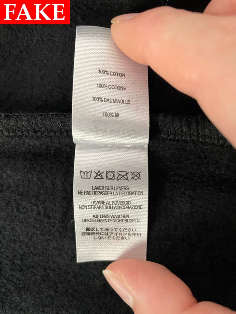 偽物のSupreme x Michael Jackson Dangerous Zip Up Hooded Sweatshirtの洗濯タグ（見開き）